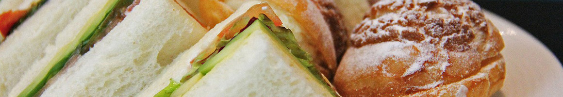 Eating Deli Hot Dog Sandwich at LA Gourmet restaurant in New York, NY.